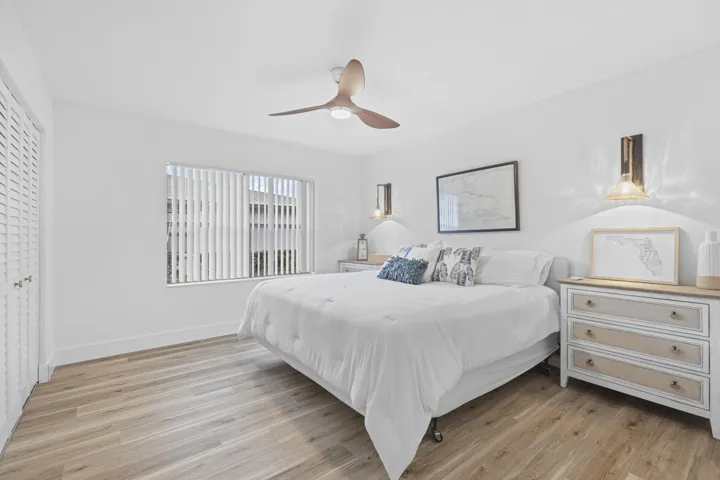 Guest bedroom with upgraded flooring, lighting, and ceiling fan