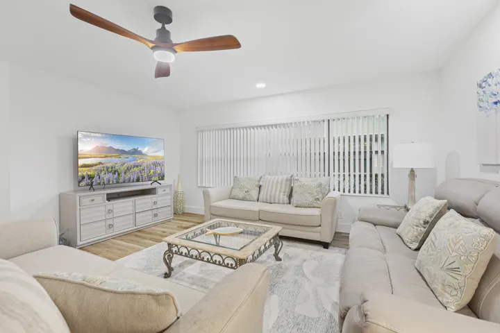 Large inviting family room with upgraded lighting and ceiling fan