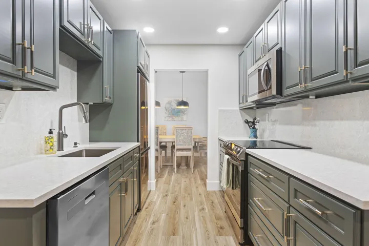 Fully remodeled kitchen with upgraded appliances and quartz countertops and backsplash