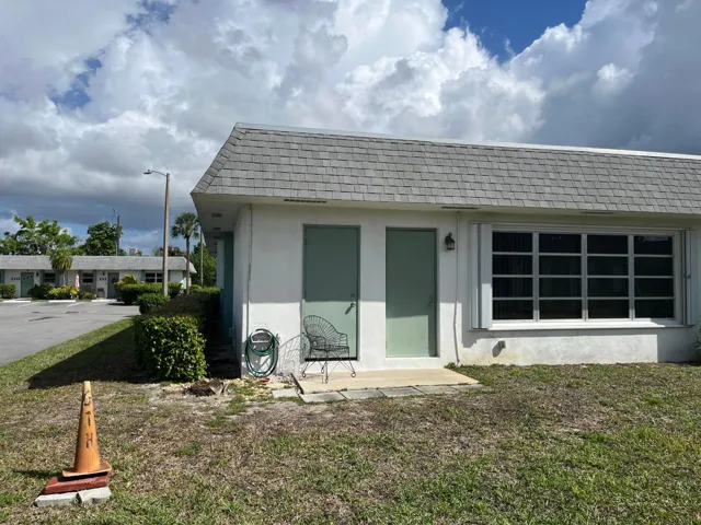 Small paver patio has doors to the family room and laundry/utility room