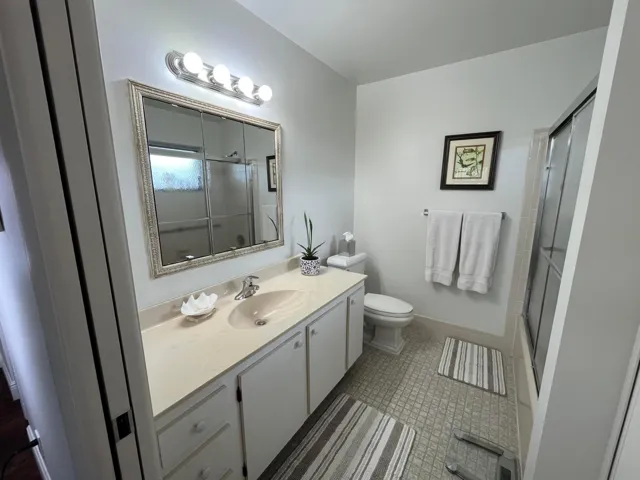 Primary bathroom has a tub and shower combination