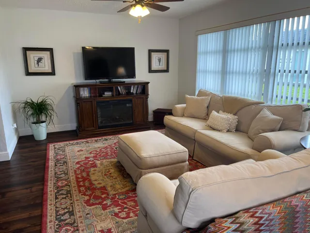 Family room has a bank of windows to provide light and air