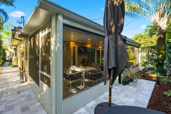 EXTERIOR BACK PATIO WITH BUILT IN BARBECUE AND HALF BATHROOM