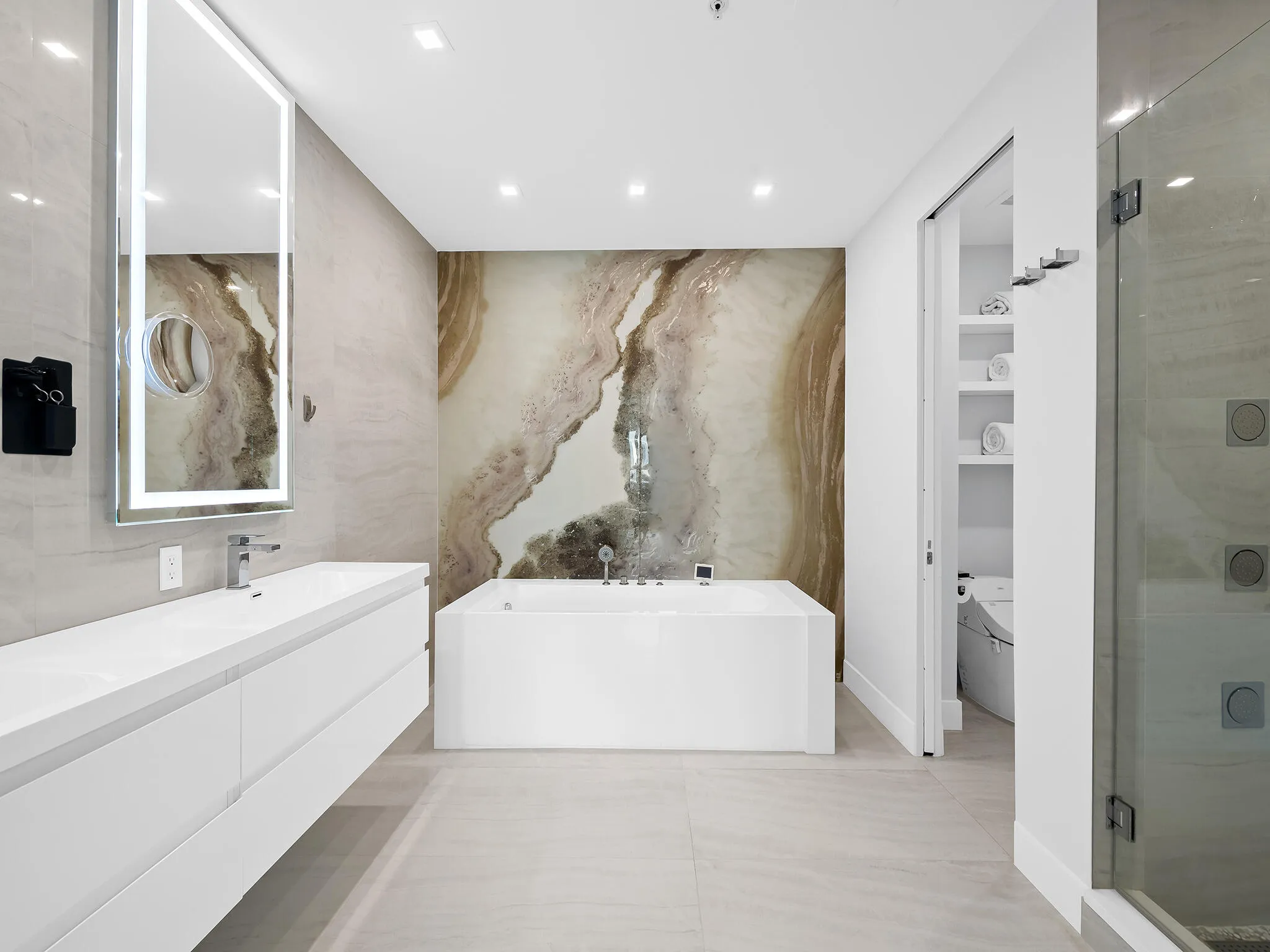 Lavish spa-like bathroom wrapped in timeless marble.