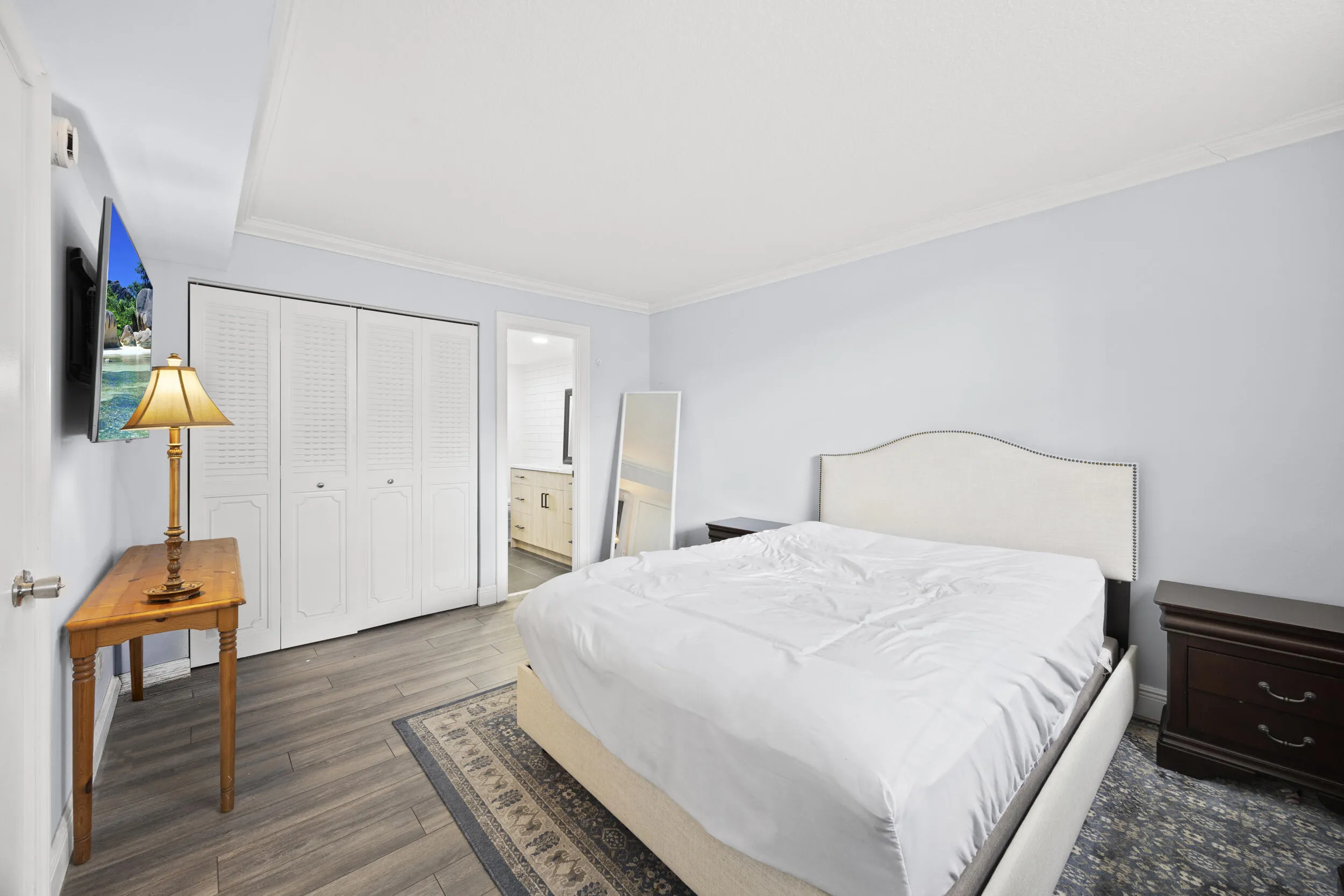 A comfortable and well-proportioned guest bedroom offering flexibility for family, visitors, or a secondary workspace. The room features ample closet space and a clean, neutral palette, creating a bright and inviting environment that easily adapts to your needs while maintaining a sense of comfort and privacy.