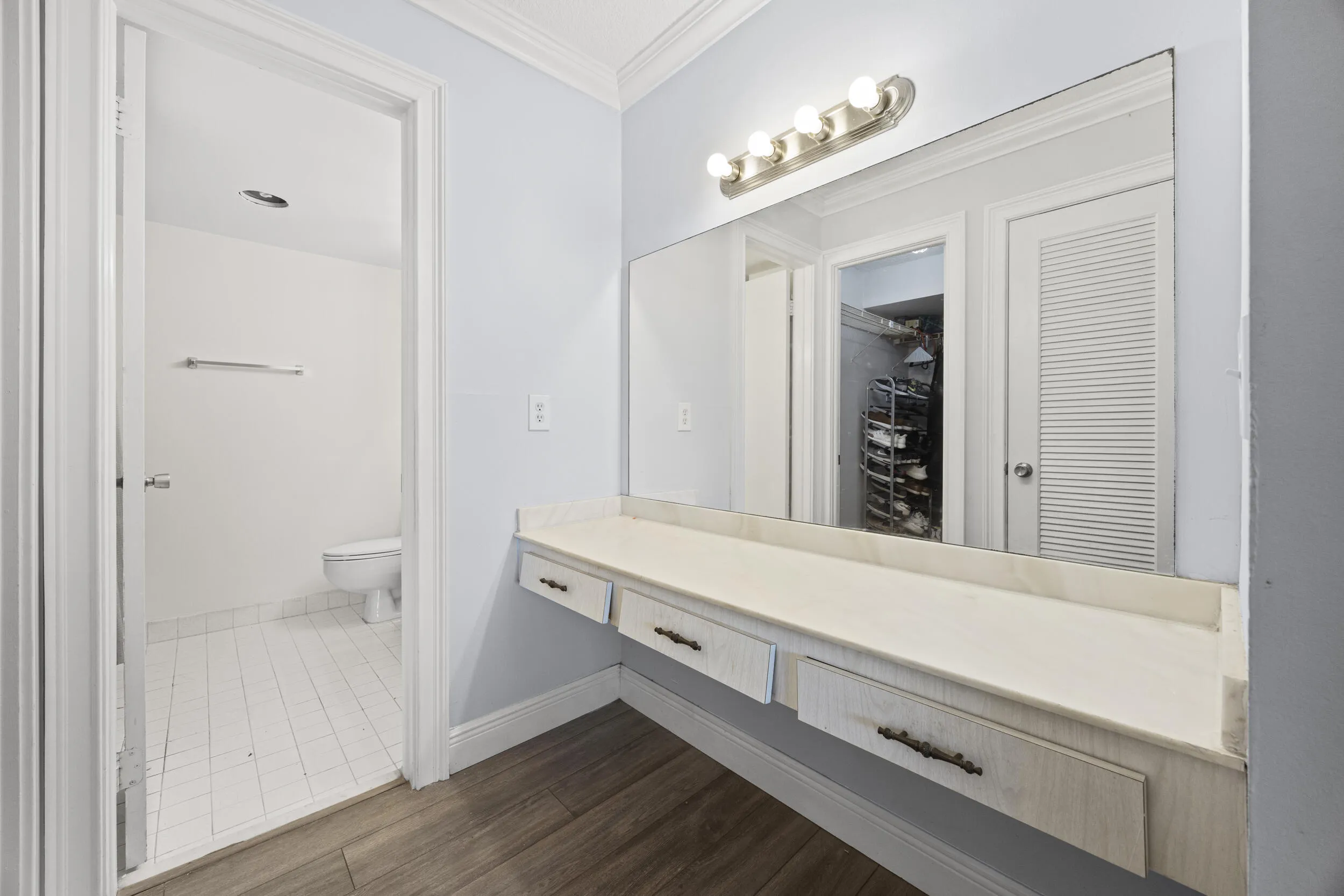 Beautifully renovated with a clean, modern design, the primary ensuite bathroom showcases a stylish new vanity with matte black fixtures, updated lighting, and a contemporary mirror. The spacious tub and shower combination is surrounded by elegant floor to ceiling tile, creating a sophisticated, spa inspired retreat that blends timeless finishes with everyday functionality.