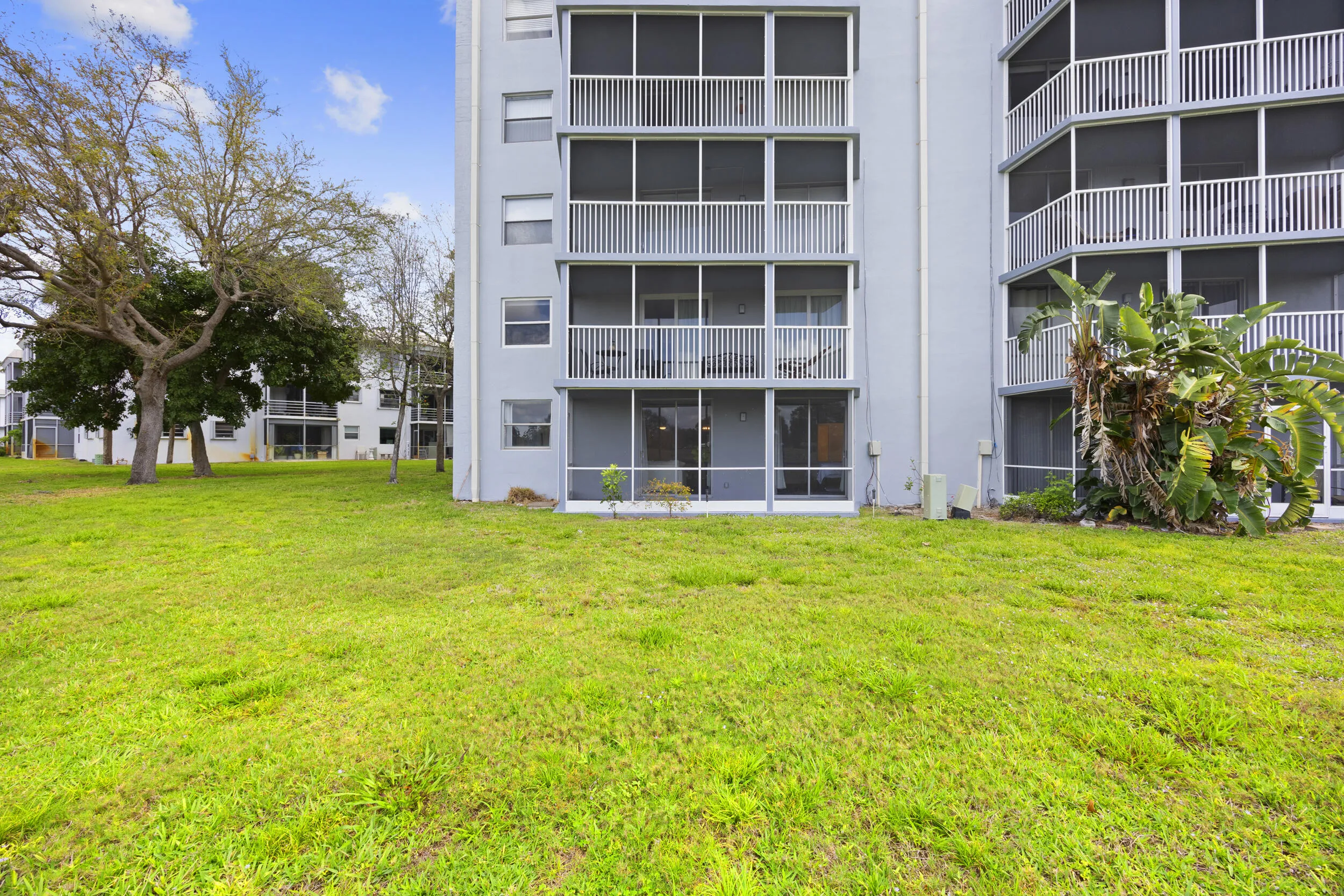 A spacious covered and screened-in patio that seamlessly extends your living space, offering a peaceful setting to enjoy the outdoors year-round. Overlooking wide open green space, this private retreat is perfect for morning coffee, evening unwinding, or simply taking in the calm and quiet surroundings that make Boca Teeca living so desirable.