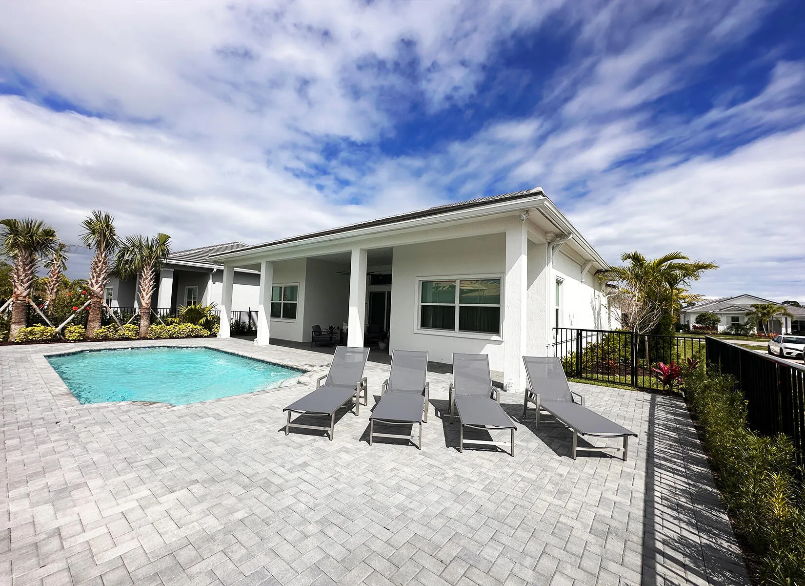 Pool deck and fenced in backyard.