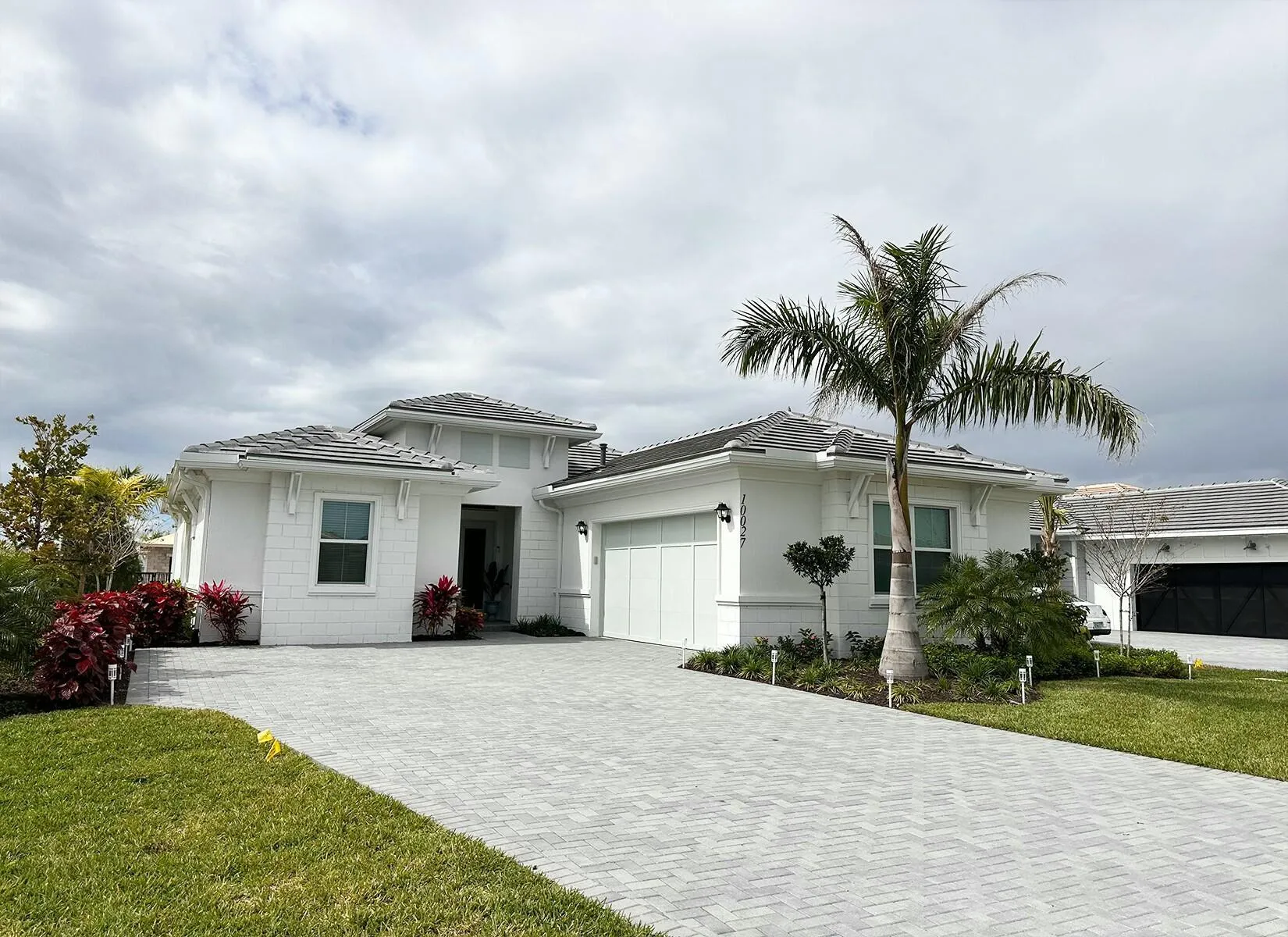 Entry to home, large driveway and 2 car garage