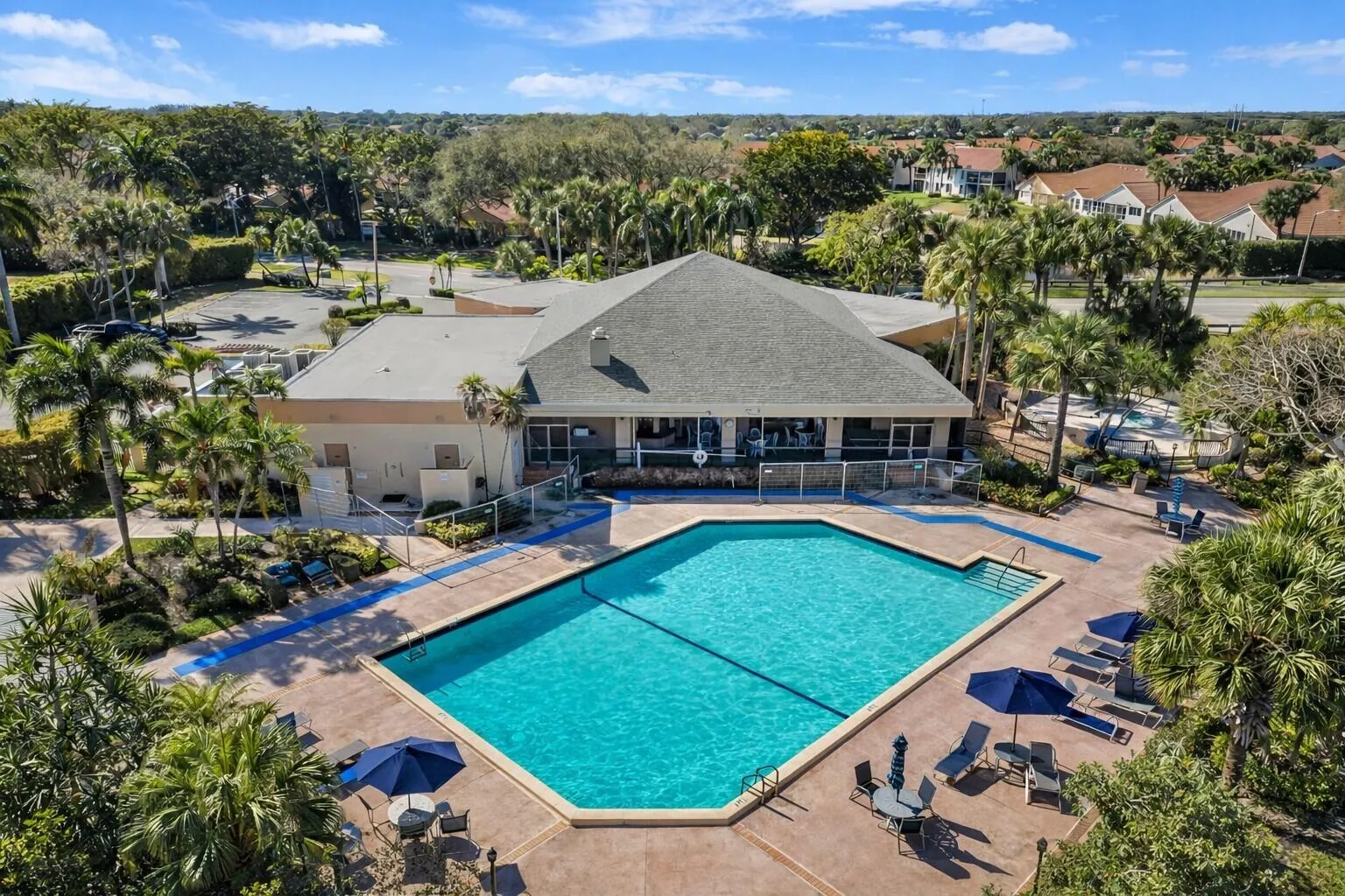 Beautiful community pool & clubhouse surrounded by lush landscaping.