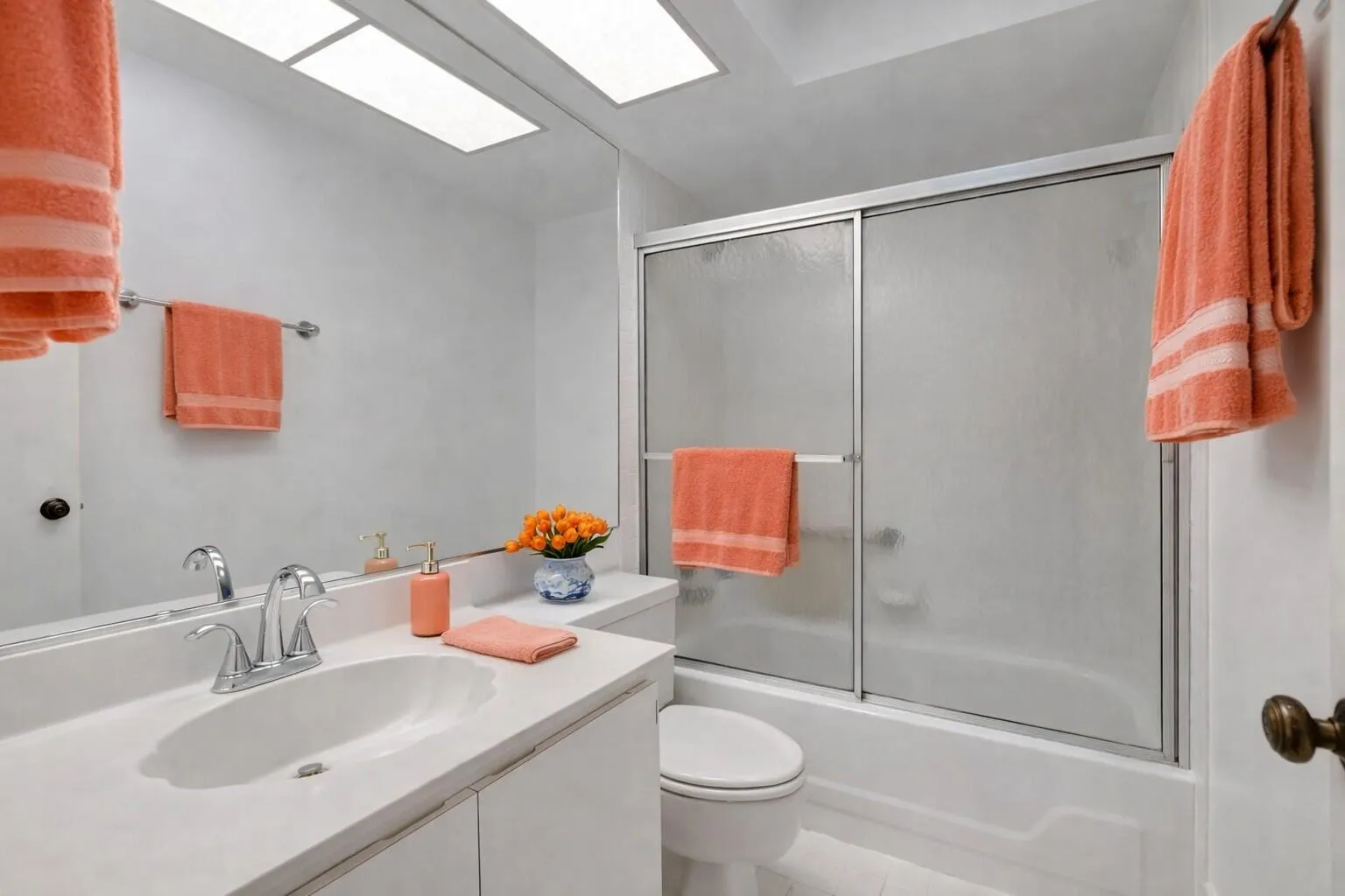 Well-kept guest bath with tub/shower combo & vanity.