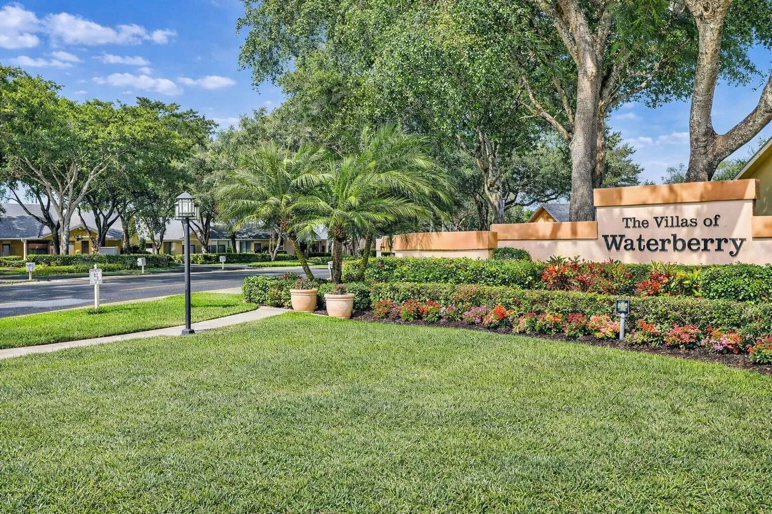 Beautiful landscaped entrance with inviting curb appeal & charm.