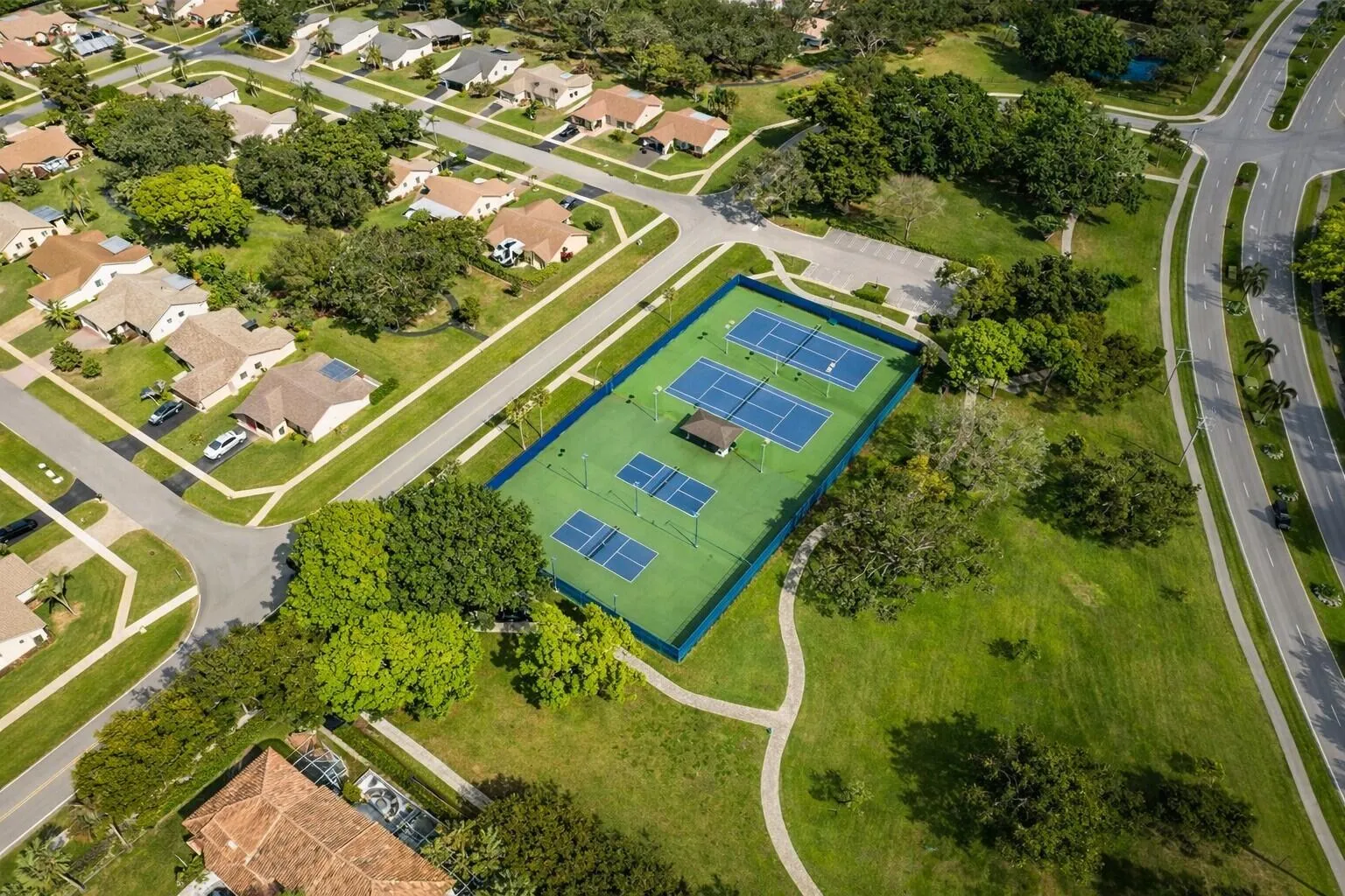 Well-maintained courts surrounded by lush landscaping & green space.