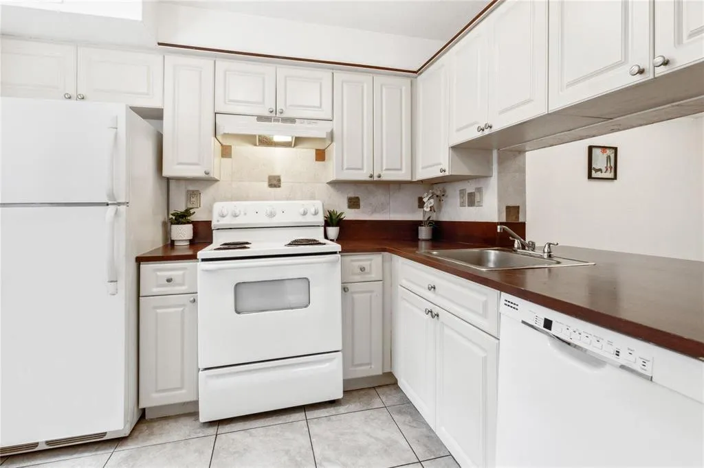 Kitchen with dishwasher, refrigerator-freezer and stove-oven.