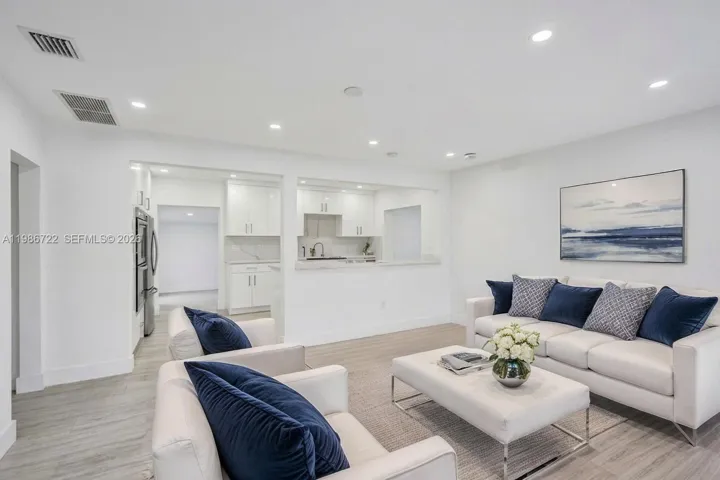 BRIGHT AND SPACIOUS LIVING ROOM WITH SLEEK VINYL FLOORING!