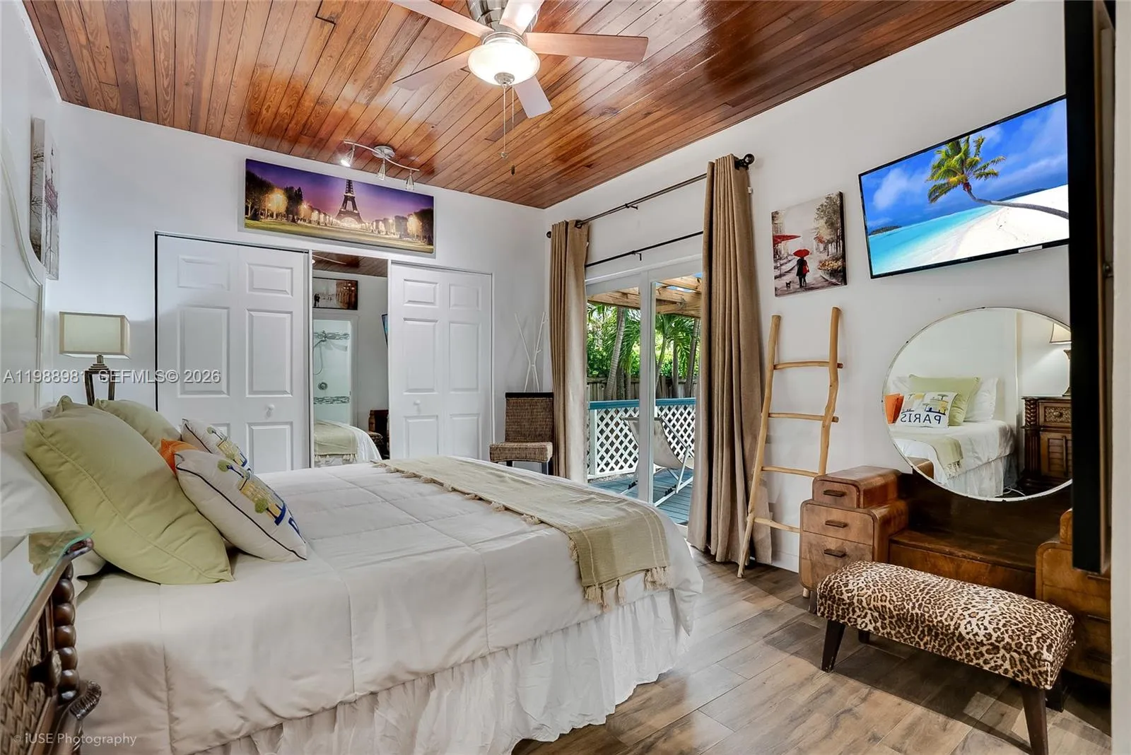 Master bedroom with a king size bed overlooks the private covered deck