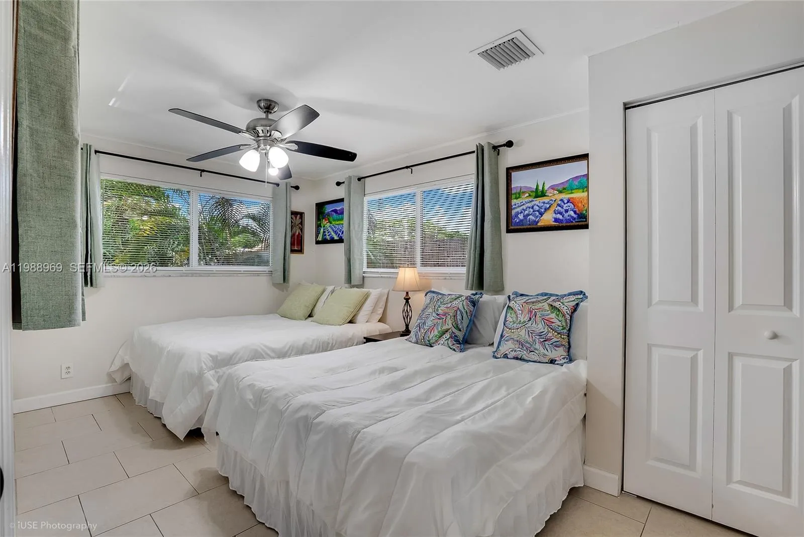 Corner Guest bedroom overlooking the backyard and private covered deck in separate wing with 2 queen size beds
