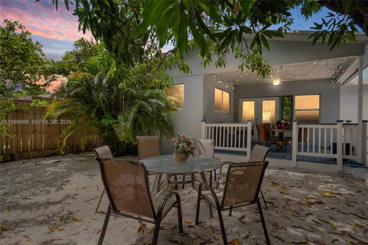 Private fenced in backyard under a huge mango tree.