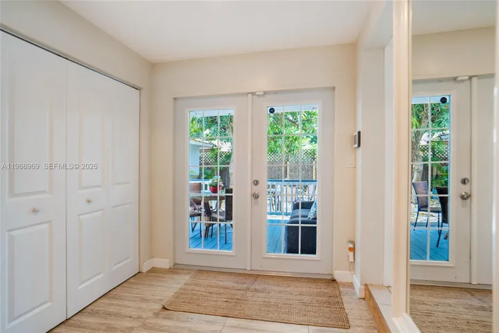 Back entrance from backyard. Laundry inside closets