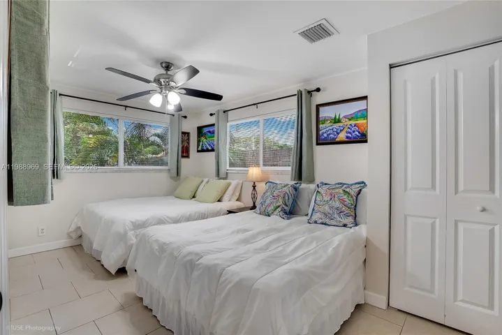 Corner Guest bedroom overlooking the backyard and private covered deck in separate wing with 2 queen size beds