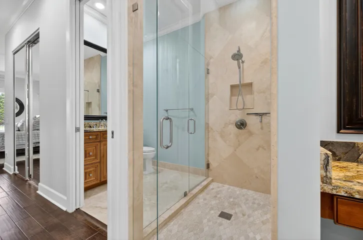 Primary bath double door shower for entry to third bath vanity.