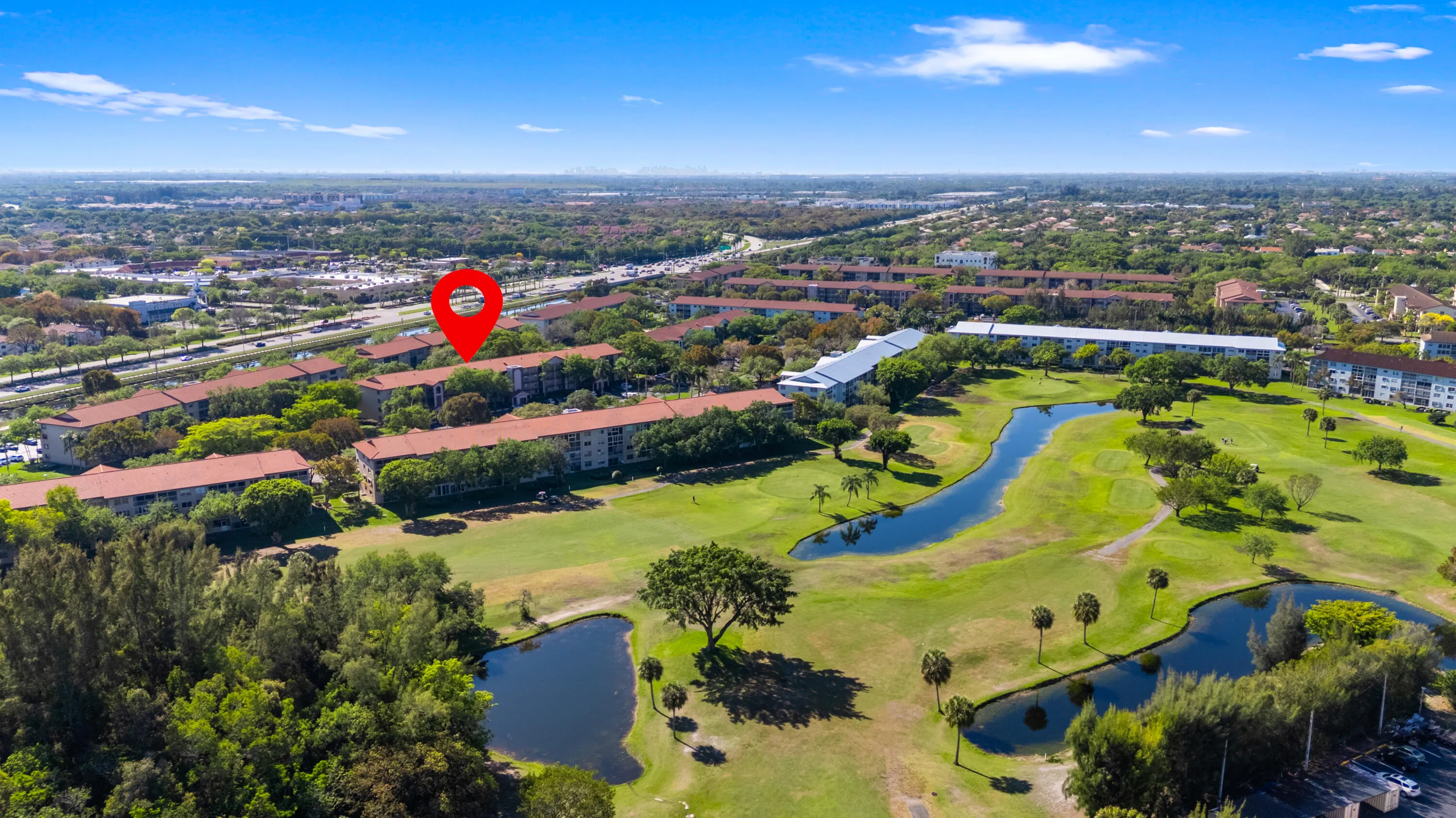 Beautiful golf course setting with water features and open green space.
