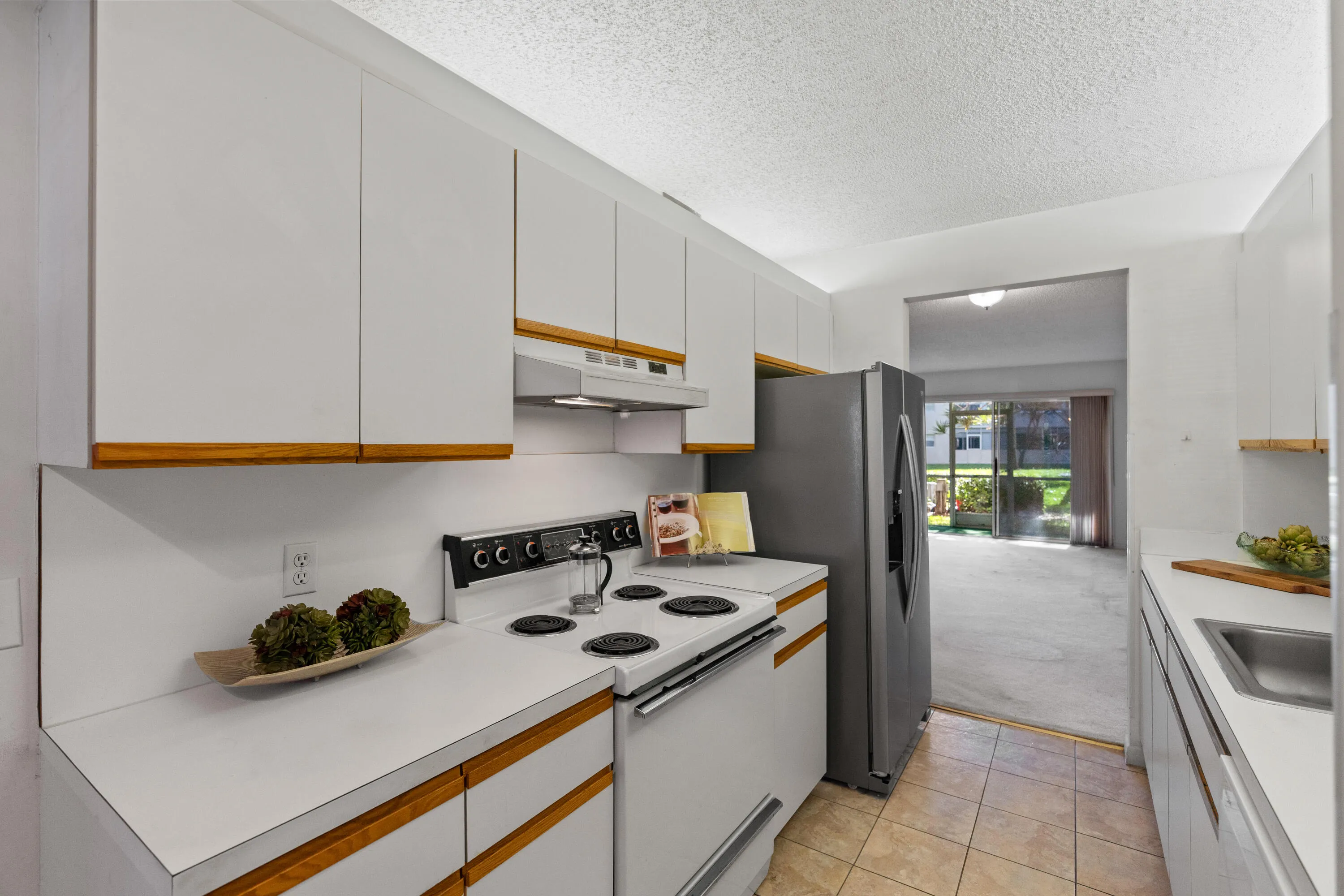 Functional layout that opens toward the main living space for easy flow. The refrigerator was replaced in January 2026. The dishwasher was replaced in 2025.