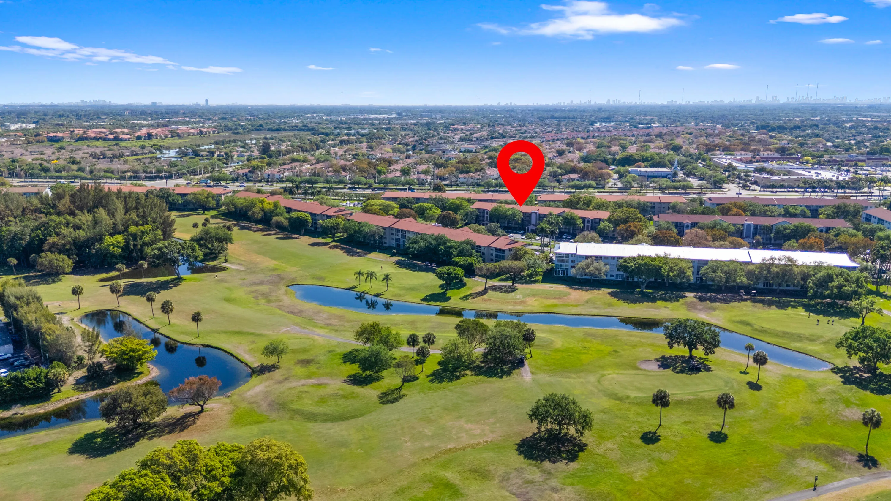 Beautiful golf course setting with water features and open green space.