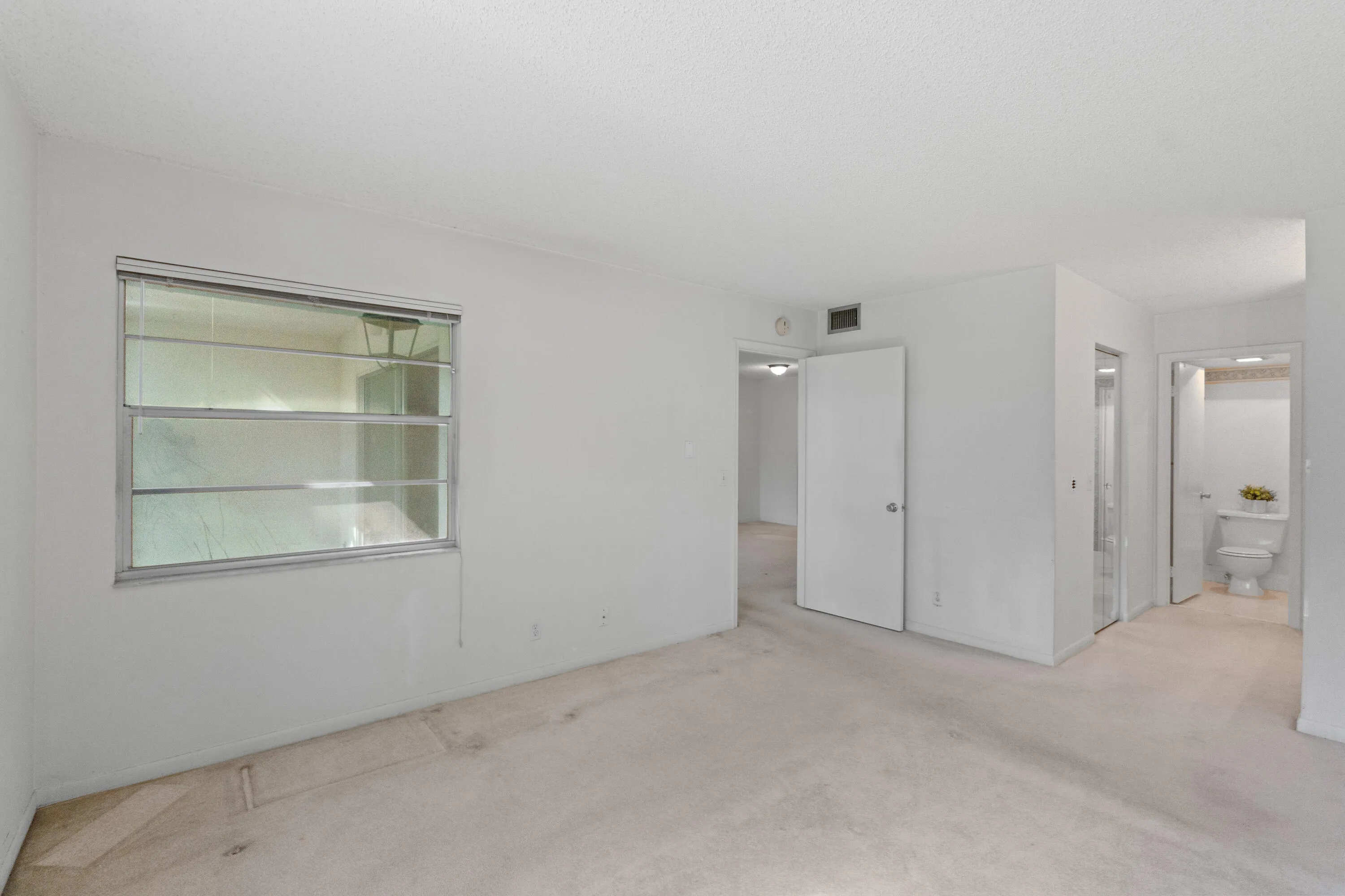 A spacious primary suite designed for comfort, privacy, and the opportunity to make it your own.