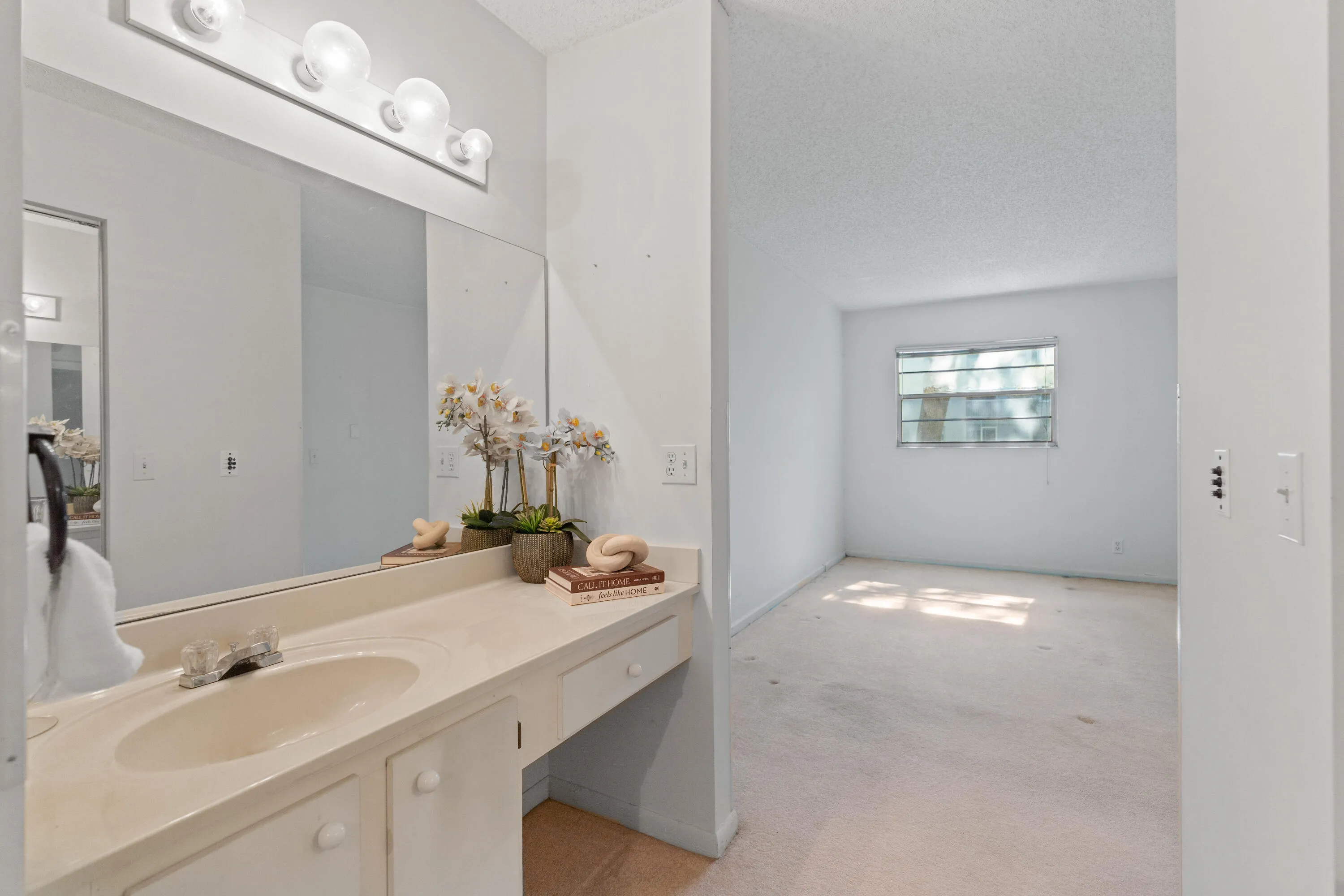 Private screened patio offering a peaceful outdoor setting with lush green views. Covered and screened for year-round comfort, ideal for morning coffee or relaxing evenings.