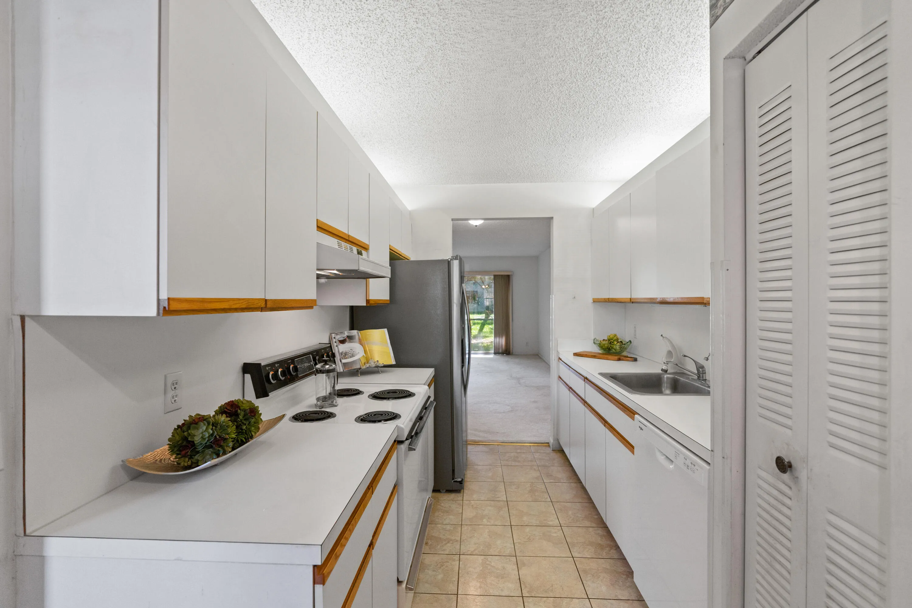 Stunning new kitchen with shaker cabinetry, quartz countertops & backsplash, new sink, faucet, flat cooktop stove/oven and microwave and a newer dishwasher and refrigerator.