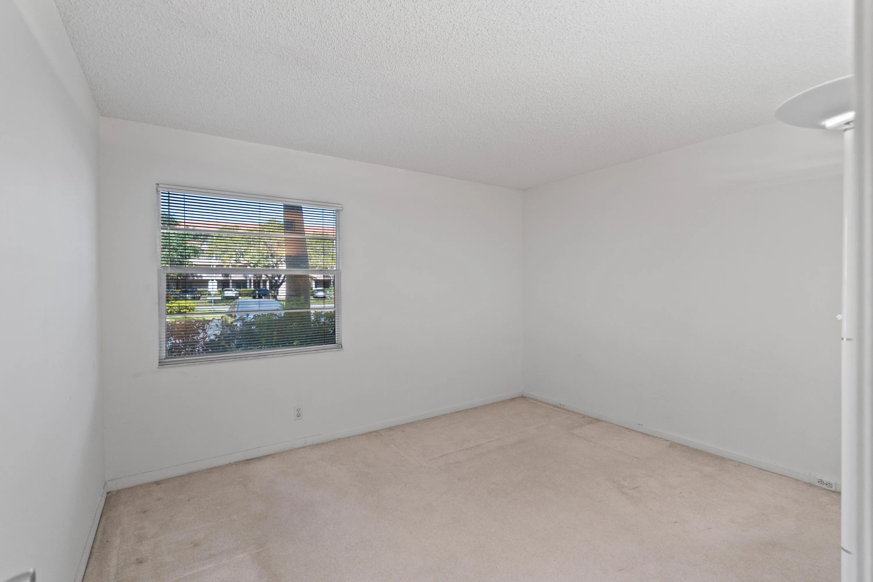 Versatile room ideal for guests, a home office, or additional living space. Well-proportioned layout with convenient access to storage.