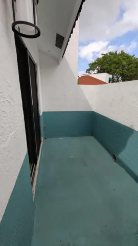 Enclosed open hybrid patio space adjacent toprimary bedroom