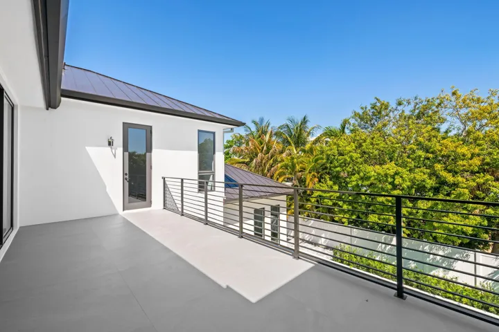 The second-floor terrace is accessible from the primary and third bedrooms.