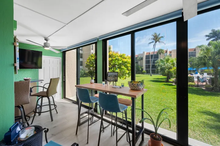 This charming Florida Room brings the outdoors in and features a storage closet, and walks right out to the pool.