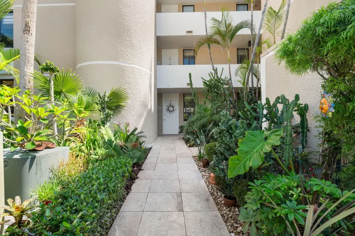 Lush, tropical landscaping greets you as you enter your first floor condo