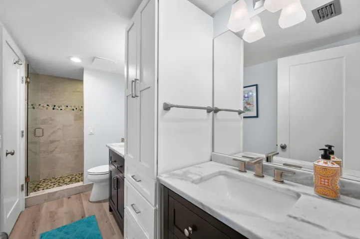 Guest bathroom features a built in linen closet.