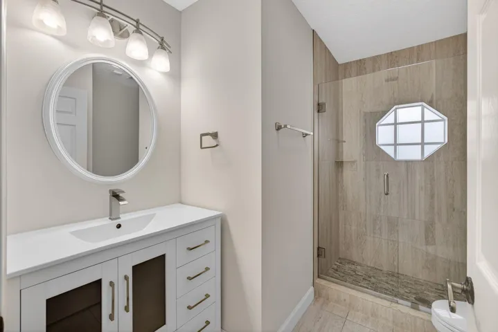 Beautiful vanity, step in shower, window