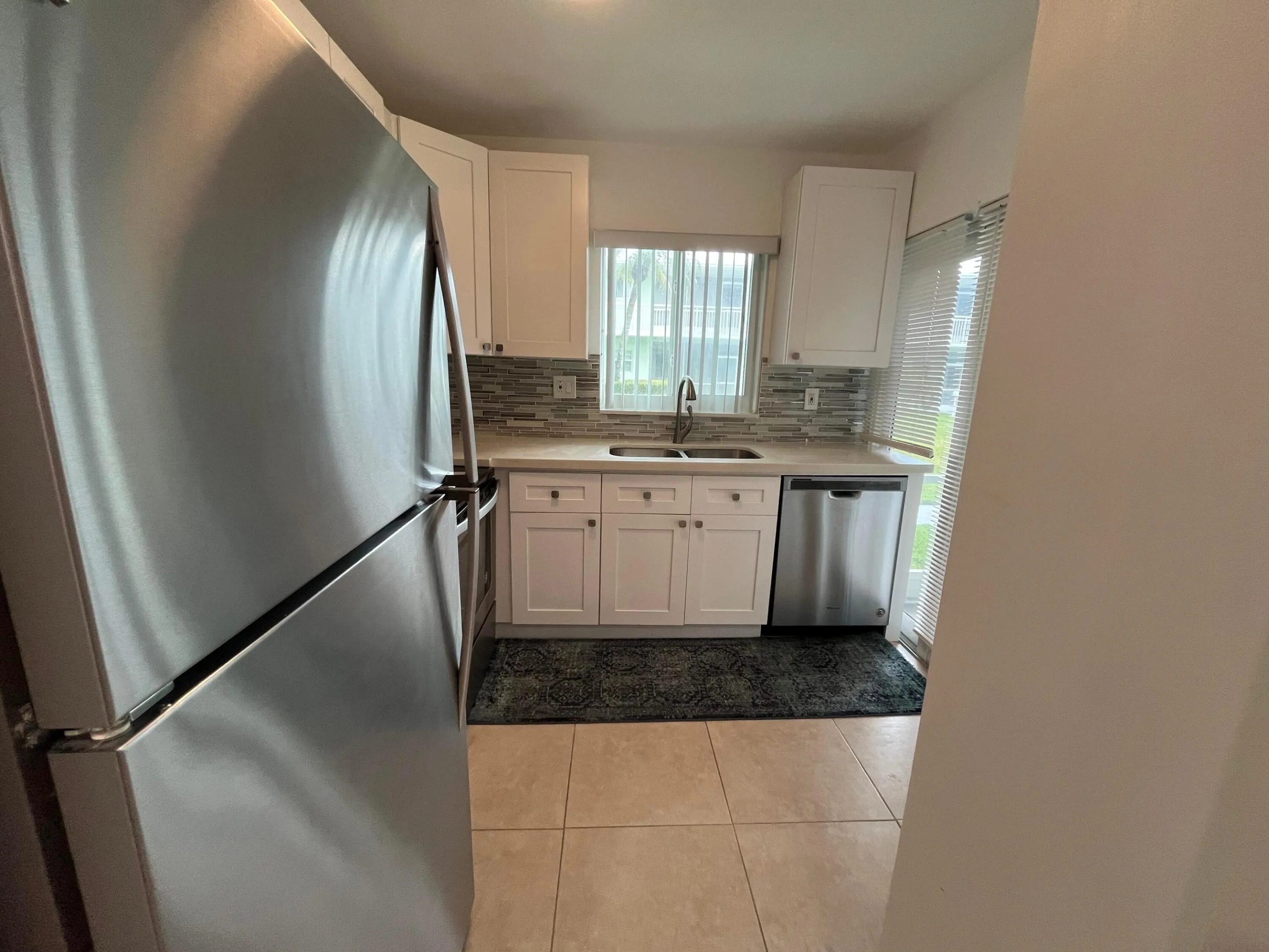The kitchen provides lots of light coming from both the window, and slider to the enclosed patio.