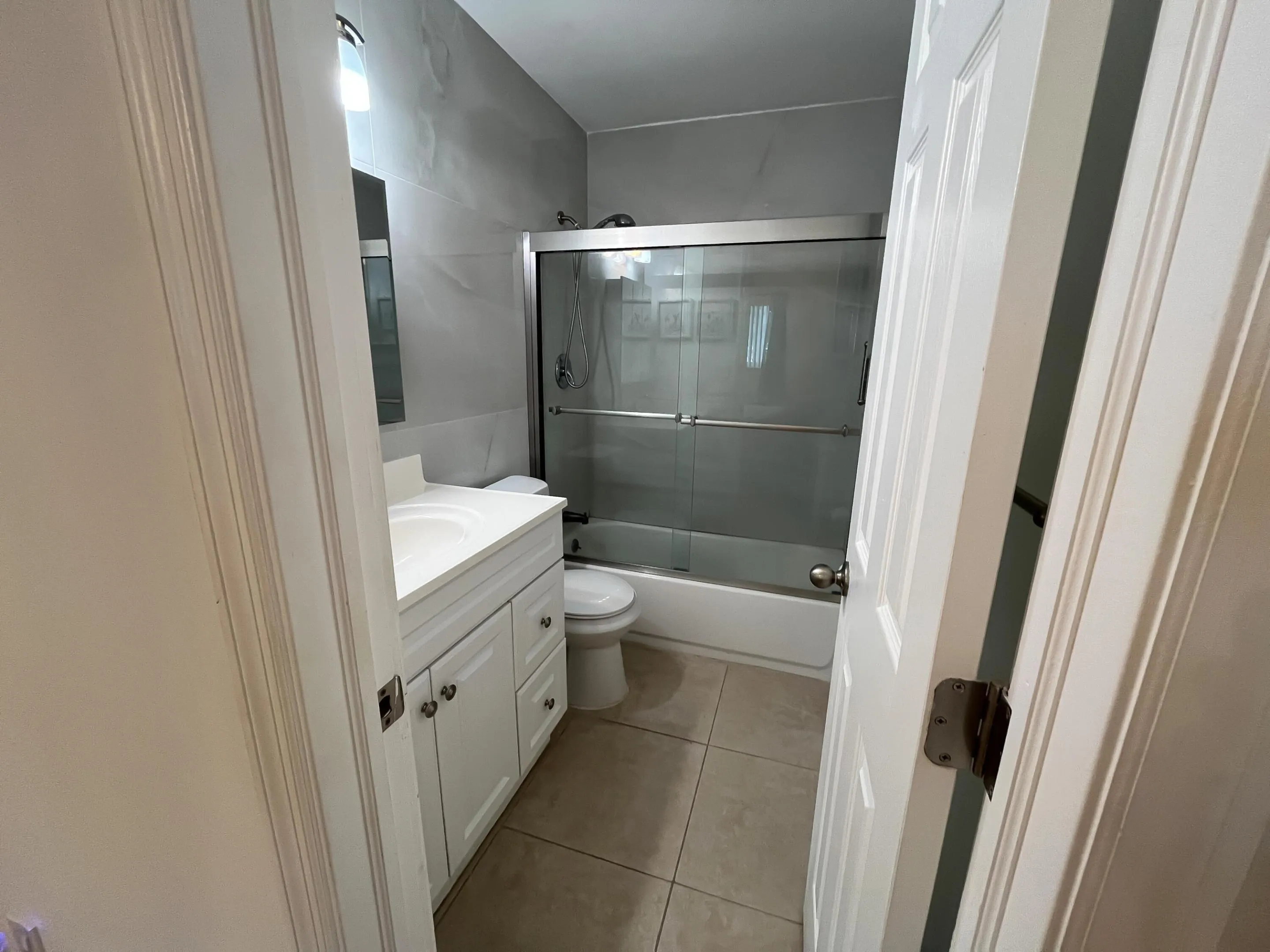 Updated primary en-suite bathroom with frameless shower doors