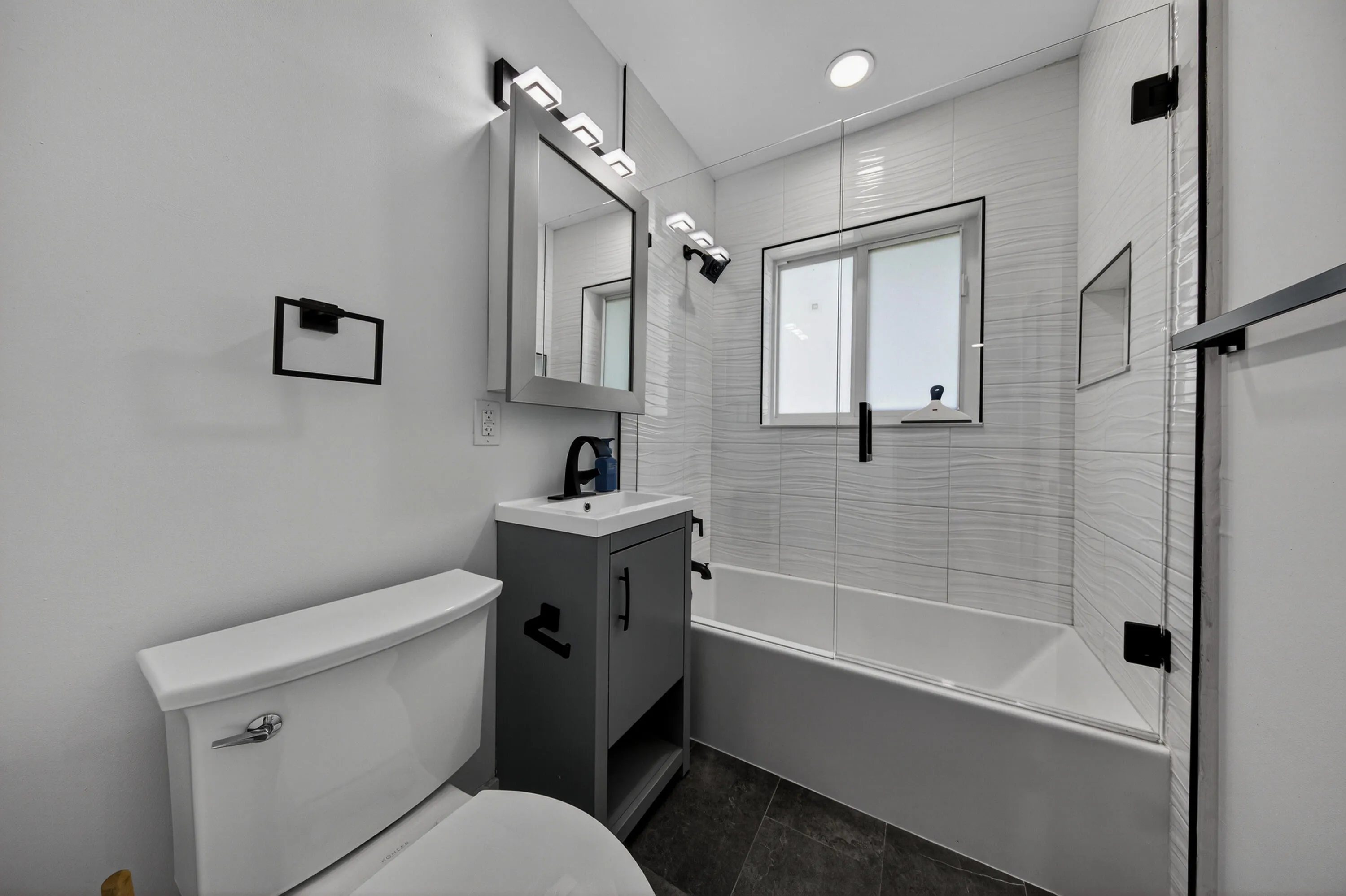Renovated full bath with tub/shower combo.