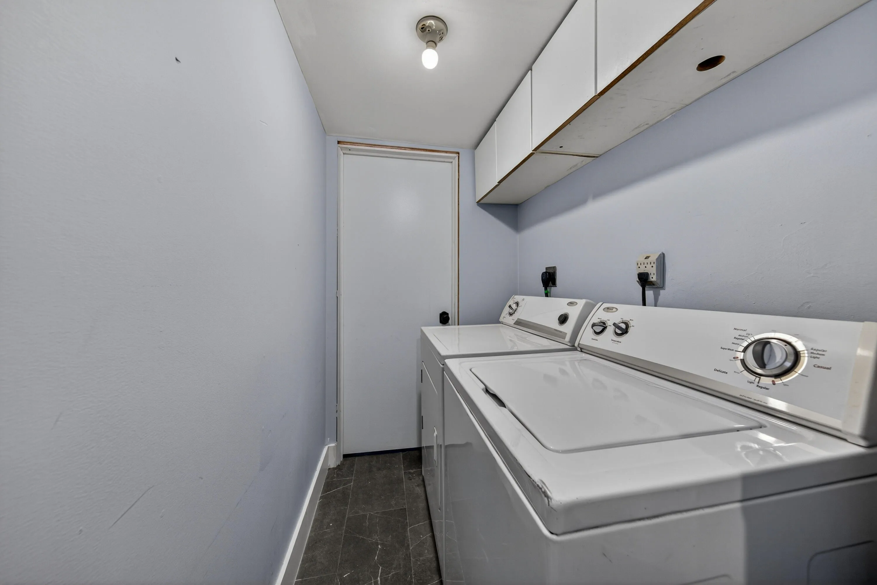 Laundry room off of kitchen with full size washer/dryer.