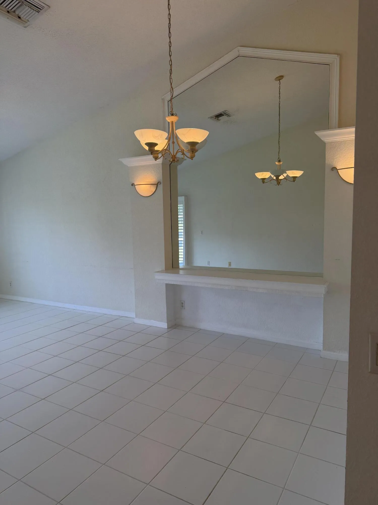 Mirrored Wall with shelf and Wall Sconces