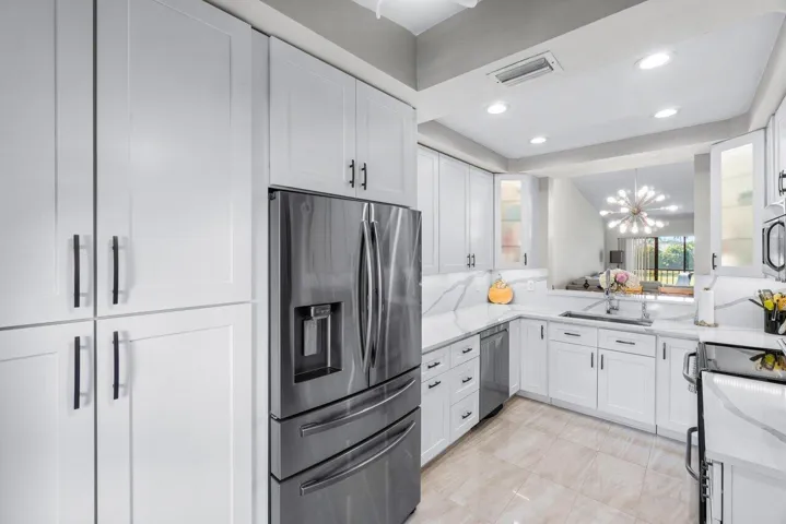 Kitchen w expansive counter & cabinets