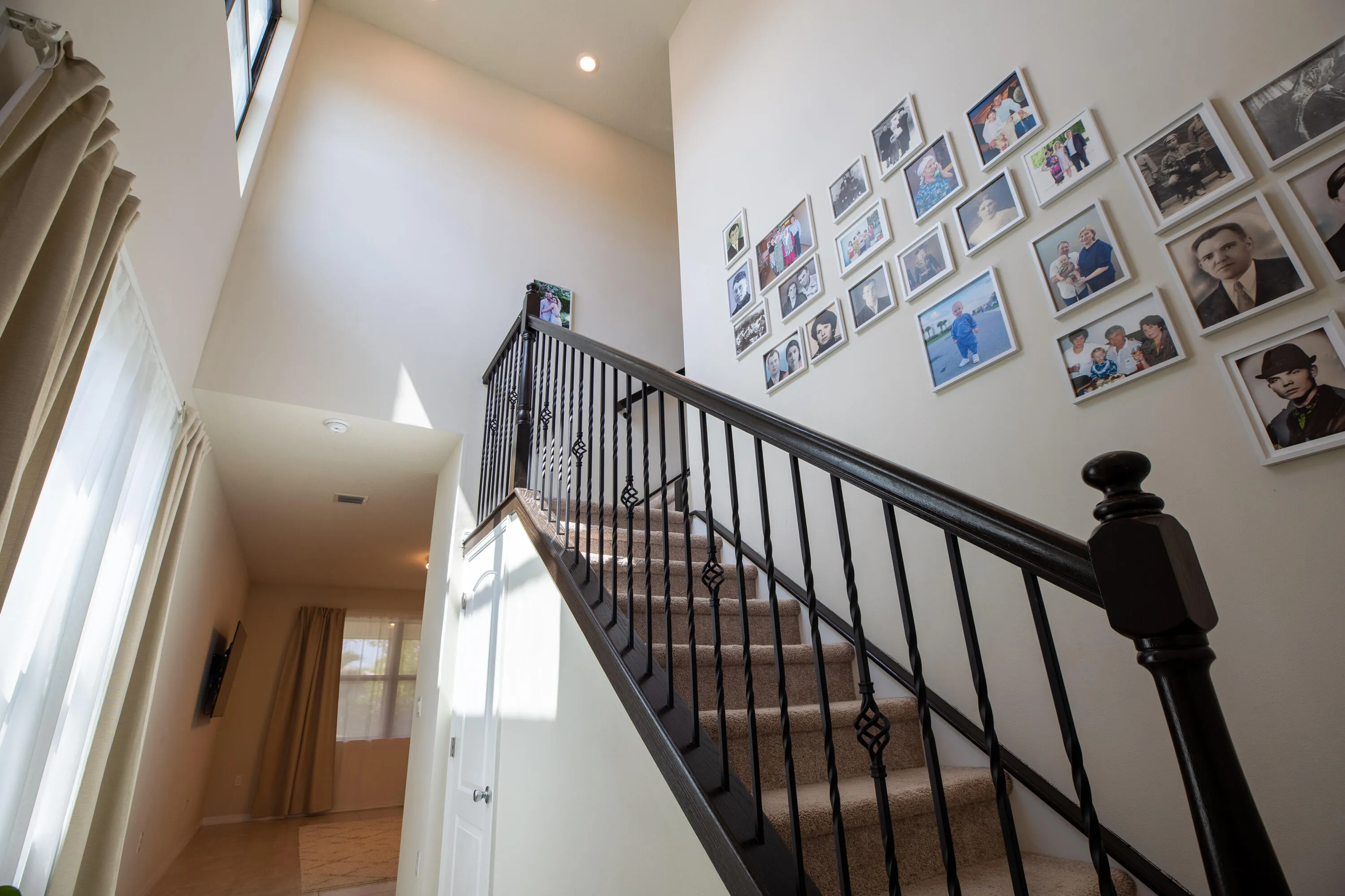 Staircase with high ceilings (approx. 19-20 ft) and abundant natural light