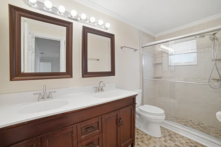 Primary Bathroom features 2 sinks and two oversized mirrored medicine cabinets