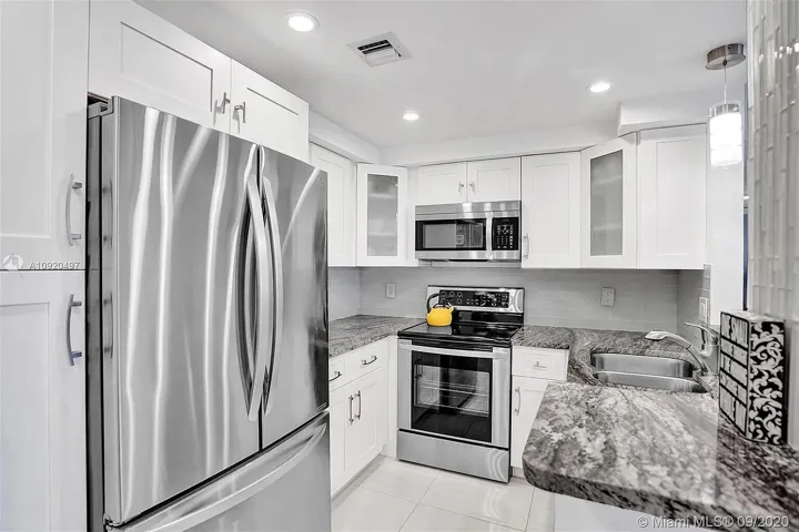 Open kitchen with stainless appliances and creative cabinets