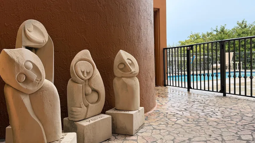 Outside a scultpure garden leads to the pool