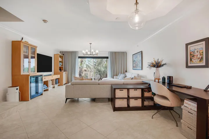 an open floor plan with beautiful flooring and lighting fixtures