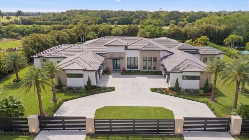 Front of home. Double gated drive, four large garage bays, fully fenced 1.82 acres.